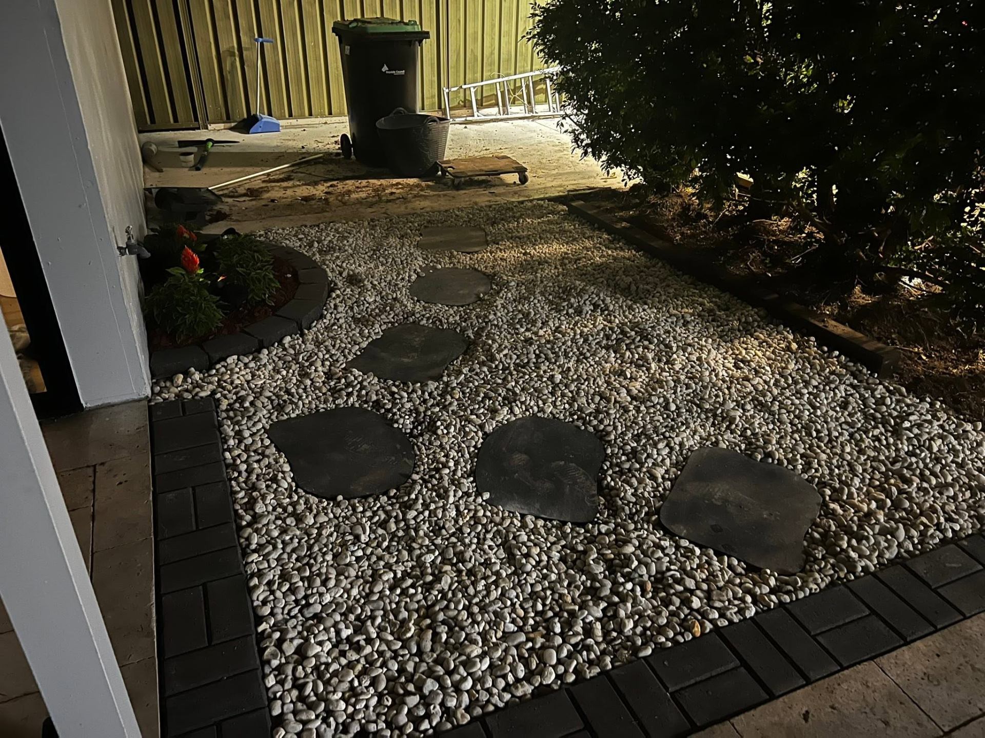 White pebble and stepping-stone path with brick edging